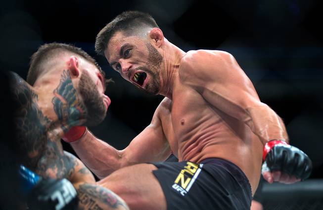 Bantamweight championship fighter Cody Garbrandt absorbs another blow from Dominick Cruz during their UFC 207 fight at the T-Mobile Arena on Friday, Dec. 30, 2016.