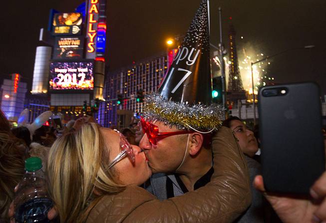 Mirna Malagon and her husband Ariel of Dos Palos, Calif. celebrate the new year just after midnight as fireworks explode above the Las Vegas Strip Sunday, Jan. 1, 2016.