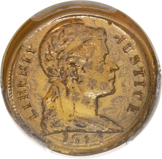 This undated photo provided by Heritage Auctions shows a glass U.S. penny. The rare coin was manufactured as a possible alternative to copper during WWII. Heritage Auctions announced Friday, Jan. 6, 2017, that the penny was sold during Thursday's auction based in Fort Lauderdale to an American buyer who wishes to remain anonymous.