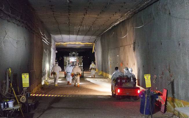 This Jan. 4, 2017, image provided by the U.S. Energy Department and its contractor Nuclear Waste Partnership shows workers moving waste underground at the Waste Isolation Pilot Plant near Carlsbad, N.M. The repository, the federal government's only underground spot for disposing of low-level nuclear waste, had been shuttered for nearly three years since a 2014 radiation release.