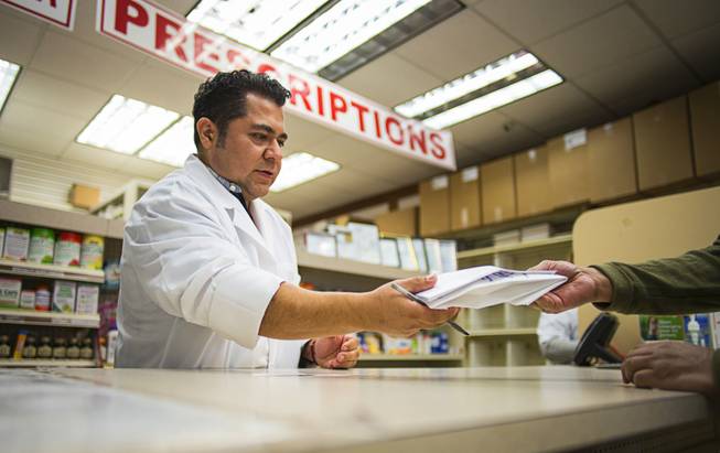 A pharmacy worker assists with an order at Prime Aid Pharmacy in Union City, N.J., Dec. 7, 2016. Prime Aid is fighting to stay in business and suing Express Scripts in federal court, alleging that the company used strong-arm tactics to kick Prime Aid out of its network and steer its patients into Express Scripts’s own, competing pharmacy, Accredo. 