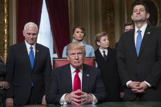 President Donald Trump is joined by the Congressional leadership and his family before formally signing his cabinet nominations into law, Friday, Jan. 20, 2107, in the President's Room of the Senate on Capitol Hill in Washington. From left are, Vice President Mike Pence, the president's wife Melania Trump, their son Barron Trump, and House Speaker Paul Ryan of Wis. (AP Photo/J. Scott Applewhite, Pool)