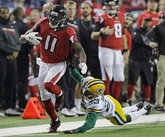 The Atlanta Falcons' Julio Jones, left, catches a touchdown pass in front of the Green Bay Packers' Damarious Randall during the second half of the NFC championship game Sunday, Jan. 22, 2017, in Atlanta.