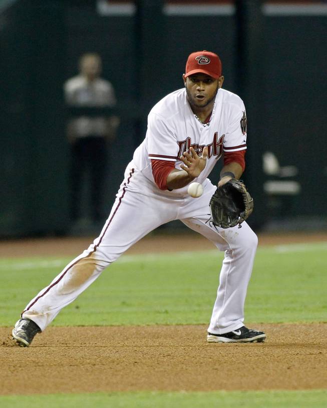Arizona Diamondbacks third baseman Andy Marte fields a ground ball by the Pittsburgh Pirates' Andrew McCutchen during the fourth inning of a baseball game Friday, Aug. 1, 2014, in Phoenix. Authorities in the Dominican Republic said Sunday, Jan. 22, 2017, that the former major leaguer died in a traffic accident. 