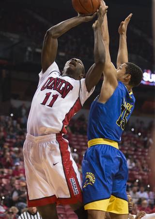 UNLV forward Cheickna Dembele (11) goes strong to the basket over San Jose State forward Brandon Clarke (15) during their game at the Thomas & Mack Center on Saturday, Feb. 11, 2017.