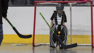 Fan Gavyn Trudel, 7, stops a ball between his knees while playing goalie on the arena floor within the T-Mobile Arena for hockey-related games as the Golden Knights hockey team holds a 24-hour open house on Tuesday, February 21, 2017.