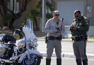 A Metro Police officer and his sergeant confer at the scene of a motorcycle accident on Decatur Boulevard near Charleston Boulevard Wednesday, Feb. 22, 2017. The motorcyclist was transported to University Medical Center in critical condition, police said. .