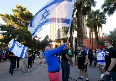 UNLV student William Moeller waves an Israeli flag at Valerie Pida Plaza before a rally at UNLV Monday, March 6, 2017. About 200 students and supporters marched and rallied to protest recent acts of anti-Semitism in Las Vegas and across the United States.