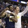 Michigan guard Derrick Walton Jr. (10) and guard Andrew Dakich (11) celebrate following a 73-69 win over Louisville in a second-round game in the men’s NCAA Tournament in Indianapolis, Sunday, March 19, 2017. 