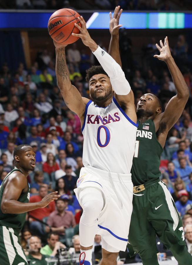 Kansas guard Frank Mason III (0) shoots in front of Michigan State guard Lourawls Nairn Jr., right, during the first half of a second-round game in the men's NCAA college basketball tournament in Tulsa, Okla., Sunday, March 19, 2017.