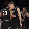 South Carolina forward Maik Kotsar (21) is congratulated by forward Chris Silva (30) after scoring against Florida during the second half of the East Regional championship game of the NCAA men's college basketball tournament, Sunday, March 26, 2017, in New York. 