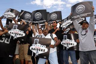 Laborers Union members, Local 872, cheer for a television camera by the Welcome to Las Vegas sign after NFL owners in Phoenix voted to approve a Raiders move to Las Vegas Monday, March 27, 2017.