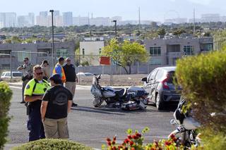 Henderson Police investigate an accident between Henderson Police motorcycle officer and a Honda Fit on Green Valley Parkway at Ramrod Avenue Tuesday, April 18, 2017.  