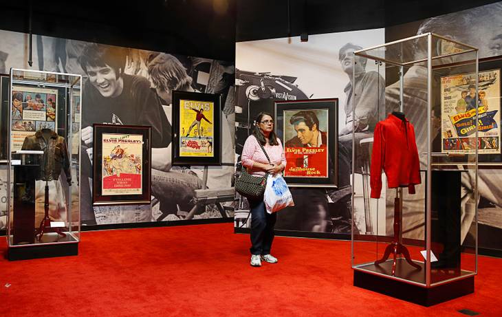In this April 23, 2015, photo, a woman tours an Elvis exhibition on the first day of "Graceland Presents Elvis: The Exhibition, The Show, The Experience" at Westgate Las Vegas. Hundreds of Elvis Presley artifacts and memorabilia are still being held by the casino, a year after the King's estate filed a lawsuit to get those valuables back.
