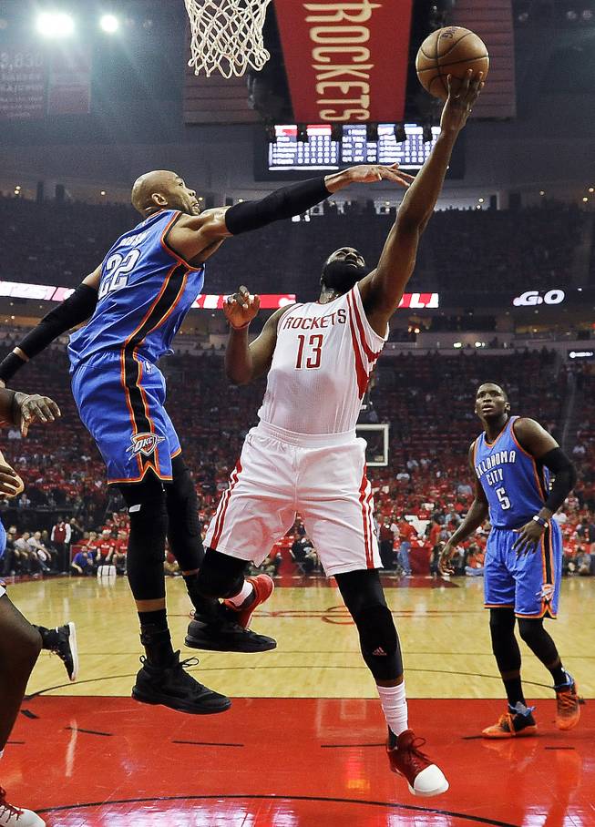 Houston Rockets guard James Harden (13) shoots as Oklahoma City Thunder forward Taj Gibson defends during the first half in Game 2 of an NBA basketball first-round playoff series, Wednesday, April 19, 2017, in Houston.