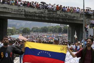 Anti-government protesters block a highway in Caracas, Venezuela, Monday, April 24, 2017. Opponents to President Nicolas Maduro shut down main roads around the country as the protest movement against his administration is entering its fourth week. (AP Photo/Fernando Llano)