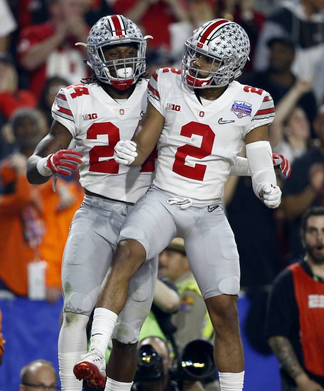 Ohio State safety Malik Hooker (24) celebrates his interception against Clemson with teammate Marshon Lattimore (2) during the first half of the Fiesta Bowl NCAA college football playoff semifinal, Saturday, Dec. 31, 2016, in Glendale, Ariz.