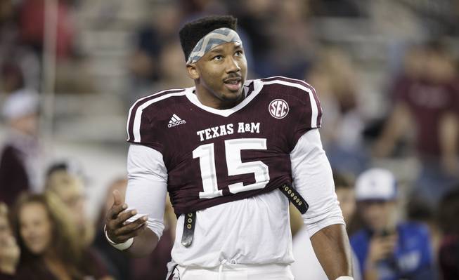 Texas A&M defensive lineman Myles Garrett (15) talks to teammates in between drills before the start of an NCAA college football game against Ole Miss Saturday, Nov. 12, 2016, in College Station, Texas.