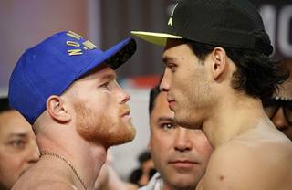 Canelo Alvarez, left, and Julio Cesar Chavez Jr. pose for photographers during a weigh-in Friday, May 5, 2017, in Las Vegas. The two are scheduled to fight Saturday in Las Vegas.