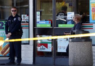 A crime scene analyst works inside a 7-Eleven convenience store after a shooting in the store at the corner of Lake Mead Boulevard and Pecos Road in North Las Vegas Monday, May 22, 2017.