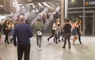 This image shows  people running through Manchester Victoria station after an explosion at Manchester Arena. in Manchester England, Monday May 22, 2017. An apparent suicide bomber set off an improvised explosive device that killed over a dozen people at the end of an Ariana Grande concert on Monday, Manchester police said Tuesday May 23, 2017.  The station is very near the arena. (Zach Bruce/PA via AP)