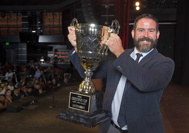 Palo Verde High School athletic administrator Jeff Dalton holds up the Greenspun Cup, a combined athletic and academic excellence award, during the second annual Las Vegas Sun Standout Awards, an award show recognizing local high school athletes, at the South Point Wednesday, May 24, 2017.