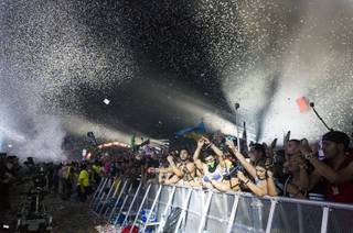 Festival goers get sprayed with confetti during Marshmello's set at the Kinetic Field stage during day three of the Electric Daisy Carnival music festival, Sunday, June 19, 2017.