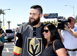 Vegas Golden Knights player Deryk Engelland takes a photo with a fan at the Welcome to Fabulous Las Vegas sign. Thursday, June 22, 2017.