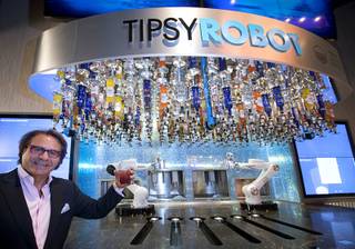 Rino Armeni, chairman of Robotic Innovations, poses by robotic bartenders in the Miracle Mile Shops at Planet Hollywood Monday, June 26, 2017. The in the Tipsy Robot automated bar is scheduled to open on Friday, he said.