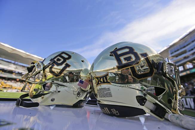 In this Dec. 5, 2015, file photo, Baylor helmets on shown the field after an NCAA college football game in Waco, Texas. 