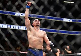 Robert Whittaker of New Zealand celebrates after five rounds with Yoel Romero of Cuba in a fight for an interim middleweight title during UFC 213 at T-Mobile Arena Saturday, July 8, 2017. Whittaker took the title with a unanimous-decision win.