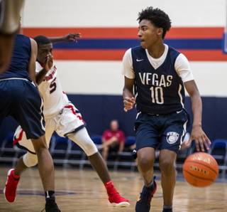Vegas Elite's Zaon Collins (10) looks to drive the Arkansas Wings' Gerald Doakes (5) during their Fab 48 Tournament U15 basketball game at Bishop Gorman High School on Wednesday, July 26 2017.  Collins already has scholarship offers from TCU and Southern Miss despite not having entered high school yet, he'll be a ninth-grader at Bishop Gorman in the fall.  L.E. Baskow
