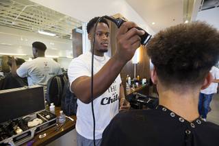 Stylist Will Lacy gives a haircut during a Back to School Party for foster children sponsored by Square Salon and the CASA Foundation Sunday, Aug. 6, 2017. The sixth annual event was expected to serve about 500 children, a spokeswoman said.