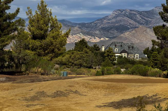 A home is shown at the shuttered Badlands Golf Course with dead greens and extensive overgrowth in the western Las Vegas Valley on Saturday, Aug. 12, 2017.