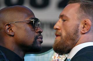 Undefeated boxer Floyd Mayweather Jr. and UFC lightweight champion Conor McGregor of Ireland face off during a news conference at the MGM Grand Wednesday, Aug. 23, 2017.