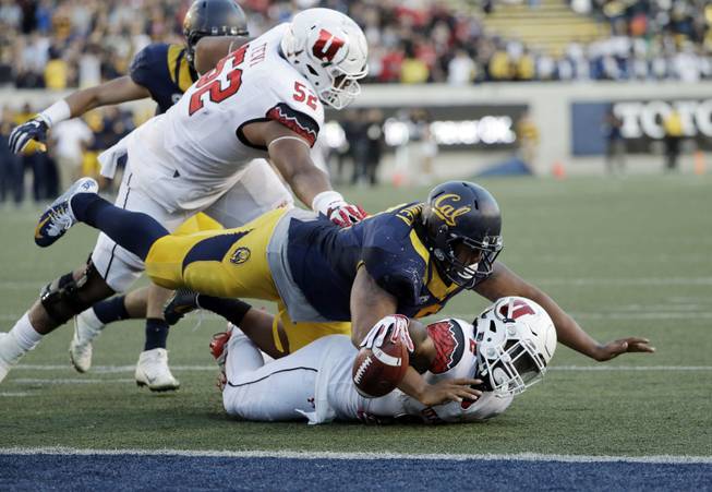 Utah running back Zack Moss, bottom, is stopped just shy of the end zone by California defensive tackle James Looney on the last play of an NCAA college football game Saturday, Oct. 1, 2016, in Berkeley, Calif. California won 28-23. 