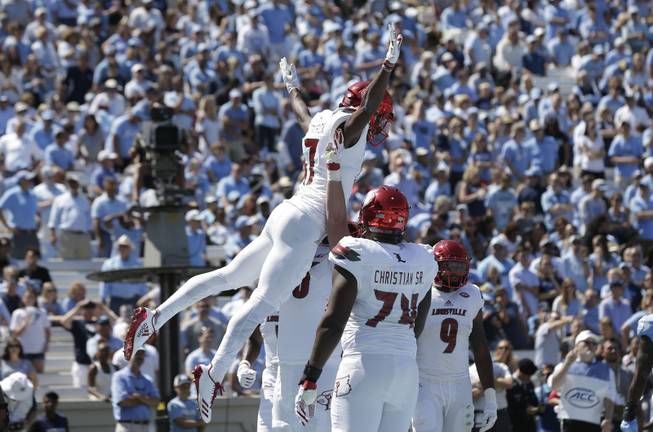 Louisville's Dez Fitzpatrick jumps while celebrating with teammates following his touchdown against North Carolina during the first half of an NCAA college football game in Chapel Hill, N.C., Saturday, Sept. 9, 2017. 