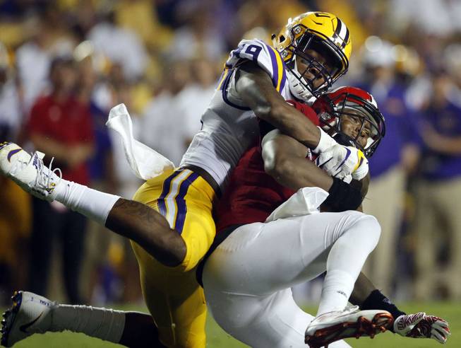 In this Sept. 10, 2016, file photo, Jacksonville State quarterback Eli Jenkins is sacked by LSU defensive end Arden Key (49) in the second half of an NCAA college football game in Baton Rouge, La. Key has been cleared to come back from shoulder surgery and play Saturday, Sept. 16, 2017 at Mississippi State. 