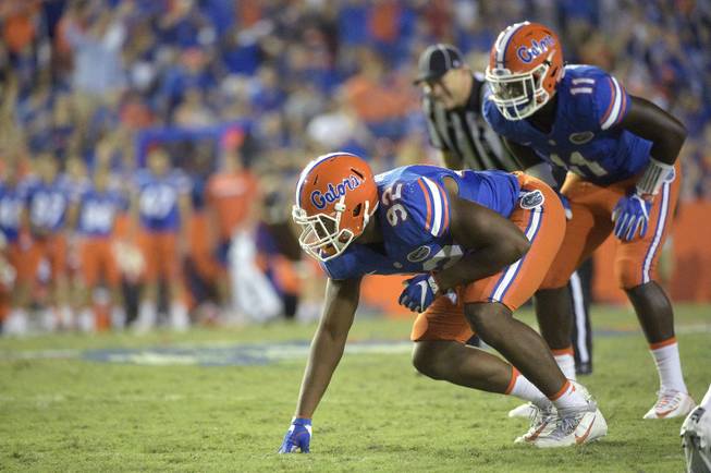 Florida defensive lineman Jabari Zuniga (92) and linebacker Vosean Joseph (11) set up for a play during the second half of an NCAA college football game against North Texas in Gainesville, Fla., Saturday, Sept. 17, 2016. Florida won 32-0. 