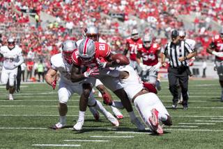 Two UNLV defenders force Ohio State receiver Parris Campbell to fumble in a game on Saturday, Sept. 23, 2017, at Ohio Stadium in Columbus, Ohio. Ohio State defeated UNLV 54-21.
