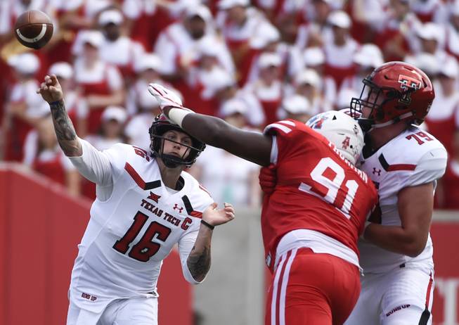 Texas Tech quarterback Nic Shimonek (16) throws a pass over Houston defensive end Nick Thurman (91) during the first half of an NCAA college football game, Saturday, Sept. 23, 2017, in Houston. 