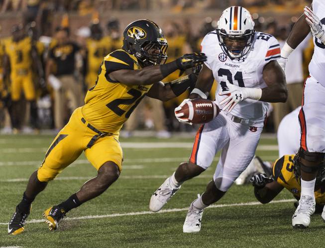 Auburn running back Kerryon Johnson, right, runs past Missouri's Logan Cheadle, left, as he scores a touchdown during the second quarter of an NCAA college football game Saturday, Sept. 23, 2017, in Columbia, Mo. 