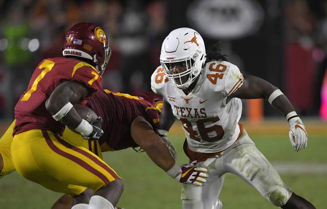 Texas linebacker Malik Jefferson, right, tries to tackle Southern California running back Stephen Carr during the second half of an NCAA college football game, Saturday, Sept. 16, 2017, in Los Angeles. USC won 27-24 in overtime. 