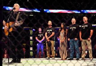 Everest sings a tribute to mass shooting heroesand survivors in the cage behind him during a break in the UFC 216 fights at the T-Mobile Arena on Saturday, October 7, 2017.   .