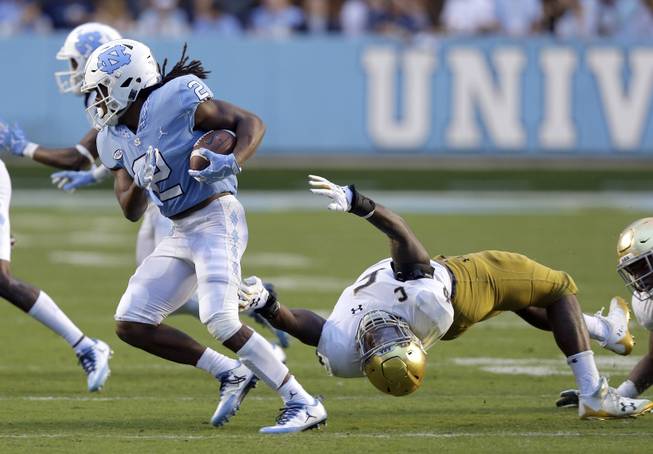 Notre Dame's Nyles Morgan (5) reaches for North Carolina's Jordon Brown (2) during the second half of an NCAA college football game in Chapel Hill, N.C., Saturday, Oct. 7, 2017. Notre Dame won 33-10. 