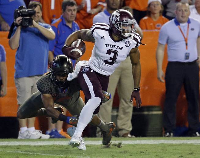 Texas A&M's Christian Kirk (3) returns a punt as Florida defensive back C.J. McWilliams can't make the tackle during the first half of an NCAA college football game, Saturday, Oct. 14, 2017, in Gainesville, Fla. 