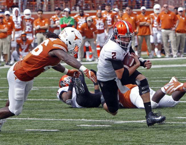 Oklahoma State quarterback Mason Rudolph (2) runs the ball against Texas linebacker Malik Jefferson during the second half of an NCAA college football game against Texas, Saturday, Oct. 21, 2017, in Austin, Texas. Oklahoma State won 13-10 in overtime.