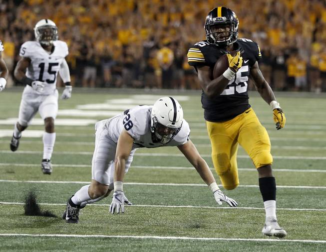 Iowa running back Akrum Wadley, right, scores past Penn State cornerback Grant Haley (15) and safety Troy Apke during the second half of an NCAA college football game Saturday, Sept. 23, 2017, in Iowa City, Iowa. (AP Photo/Jeff Roberson)