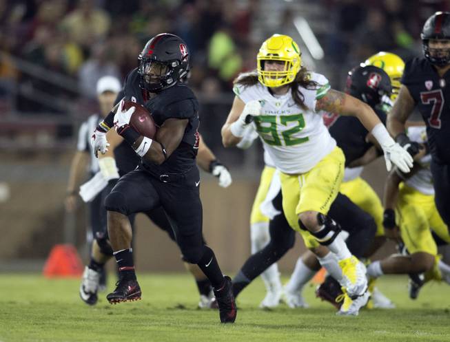 In this Oct. 14, 2017, file photo, Stanford's Bryce Love, left, breaks free for a long touchdown against Oregon during the first quarter of an NCAA college football game in Stanford, Calif. Love tweaked an ankle against Oregon and is a game-time decision for their game Thursday, Oct. 26, 2017, against Oregon State in Corvallis, Ore . (AP Photo/D. Ross Cameron, File)