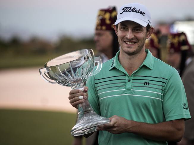 Patrick Cantlay holds his winning trophy following the final round playoff of the Shriners Hospitals for Children Open golf tournament from TPC Summerlin Sunday, Nov 5, 2017, in Las Vegas.